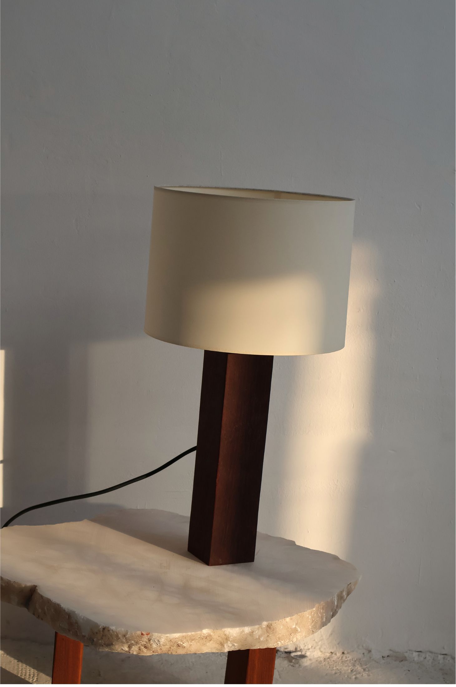 Dark wood lamp on stone