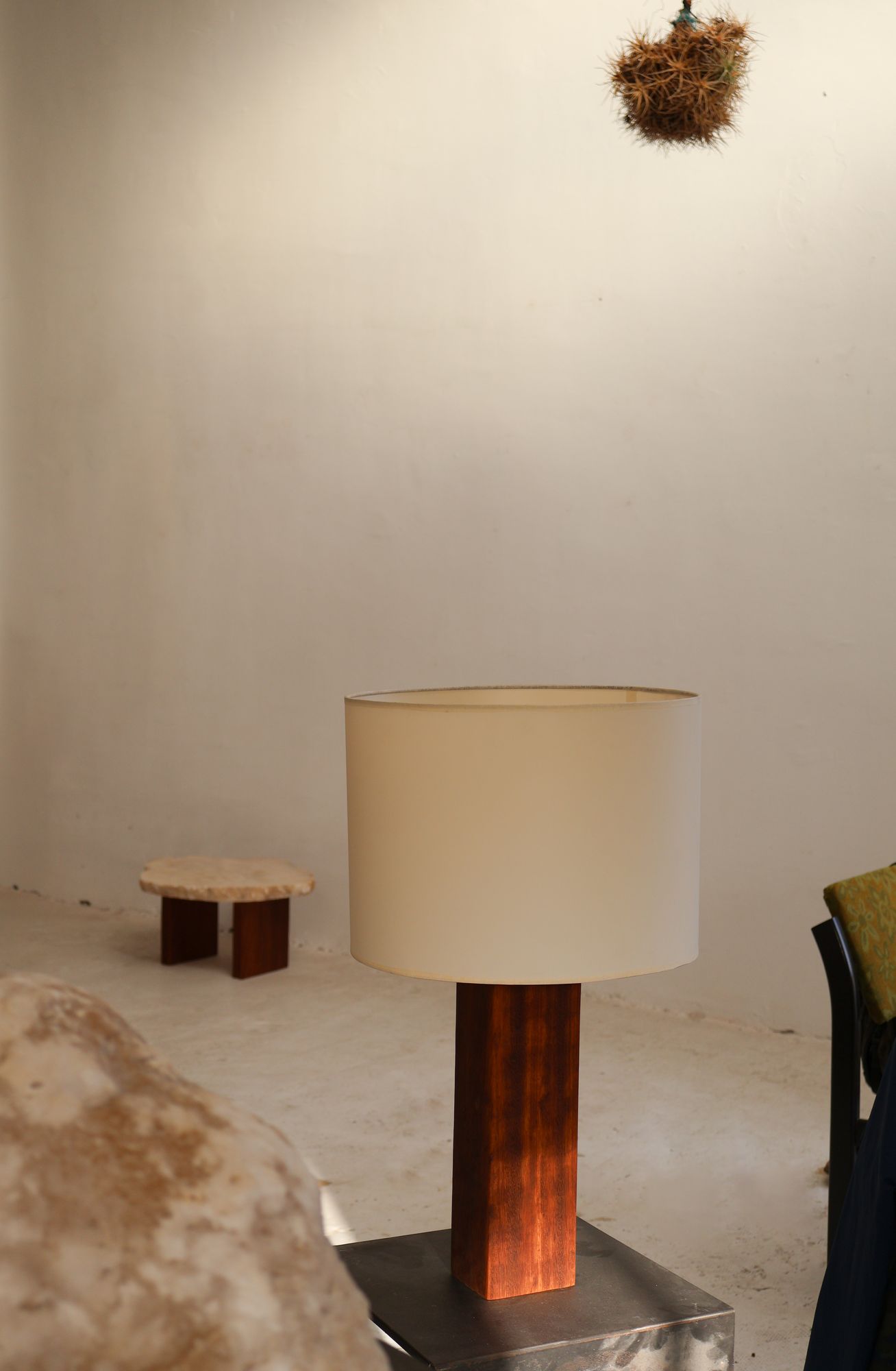 VORA HOUSE lamp beside a stone table